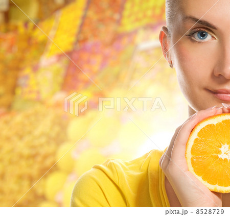 Beautiful young woman with ripe orange 8528729
