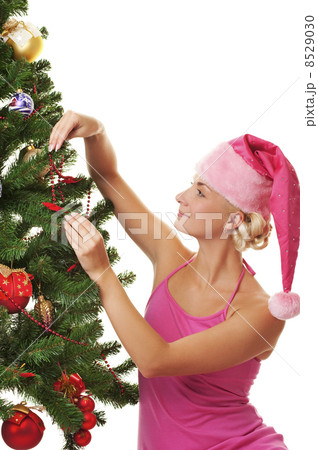 Santa girl decorating the christmas tree 8529030
