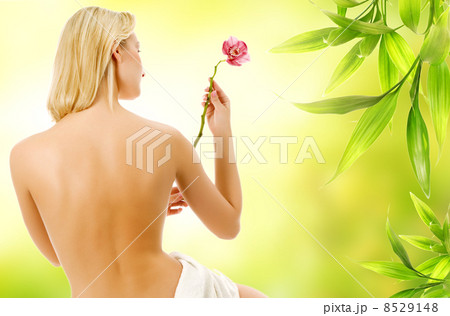 Beautiful woman with naked back over green abstract background 8529148