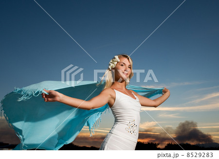 Beautiful young woman with a shawl relaxing outdoors Beautiful young woman with a shawl relaxing outdoors 8529283