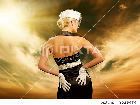 Sexy young woman over sky background. Retro portrait 8529484