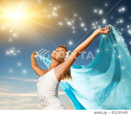 Beautiful young woman with a shawl relaxing outdoors Beautiful young woman with a shawl relaxing outdoors 8529540