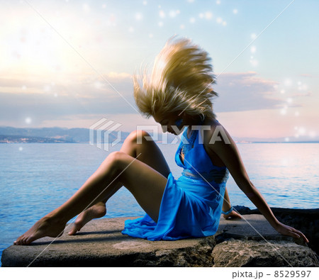 Sexy young woman flapping her blond hair near the ocean Sexy young woman flapping her blond hair near the ocean 8529597