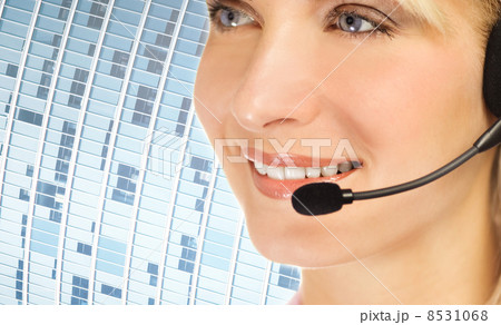 Friendly hotline operator over abstract blue background Friendly hotline operator over abstract blue background 8531068