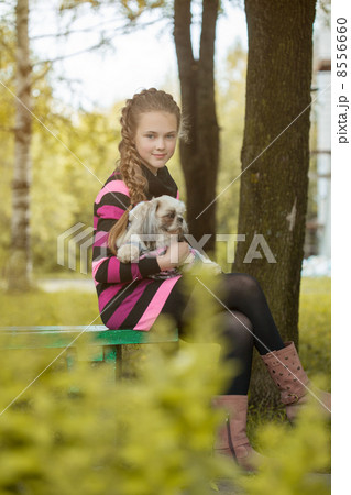 Beautiful little girl holding cute puppy 8556660