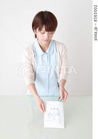 受付で薬の説明をする薬剤師 8565002