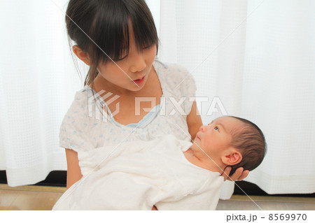 赤ちゃんを抱っこする小学生 8569970