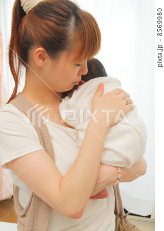 授乳の後、赤ちゃんにゲップをさせるお母さん 8569980