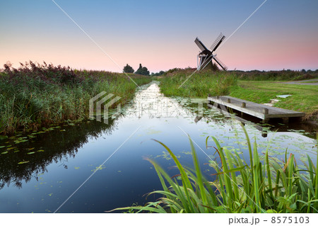 sunrise over river and Dutch windmill 8575103