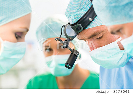 Surgeons operating patient in operation theater 8578041