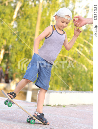 Boy Child Training Skateboard jumping Outdoor Summer Sport with nature on background Boy Child Training Skateboard jumping Outdoor Summer Sport with nature on background 8582381