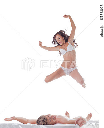 Cheerful slim woman jumping into bed with sexy guy Cheerful slim woman jumping into bed with sexy guy 8588098