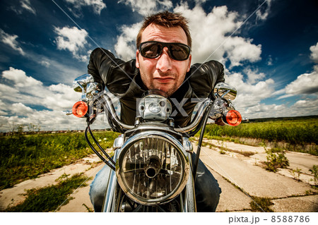 Funny Biker racing on the road 8588786