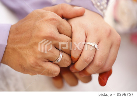 Closeup of hands of bridal couple with wedding rings Closeup of hands of bridal couple with wedding rings 8596757