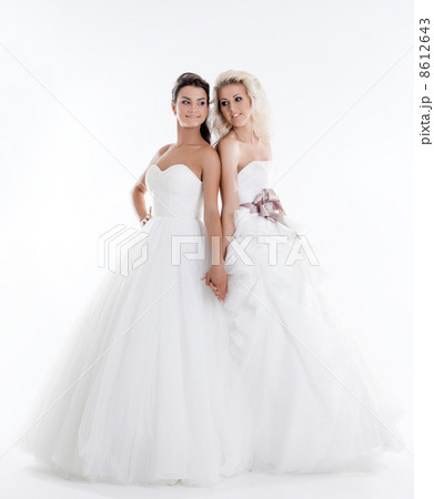 Image of beautiful shapely brides holding hands Image of beautiful shapely brides holding hands 8612643