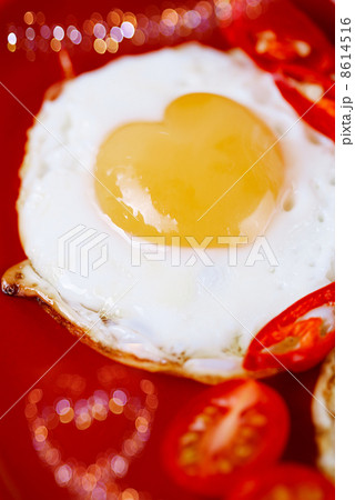 fried egg with heart shape yolks and heart shaped bokeh fried egg with heart shape yolks and heart shaped bokeh 8614516