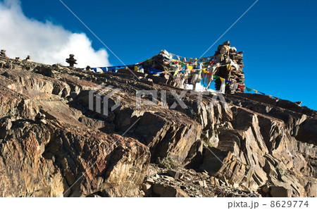 Buddhist stone tower and praying flags at Himalaya 8629774