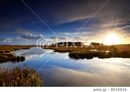 sun at sunrise over lake 8630656