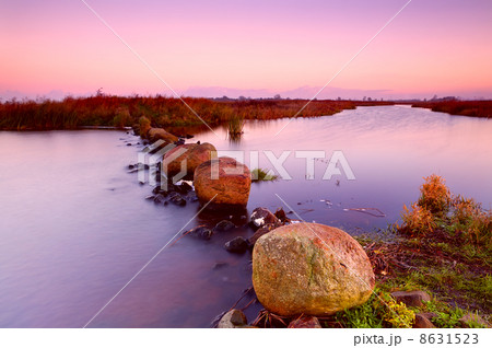 big stones on river at sunrise 8631523