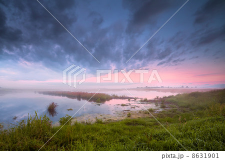 lake in fog at sunrise 8631901