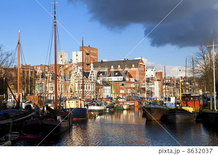 sunny canal in Groningen with many river boats sunny canal in Groningen with many river boats 8632037