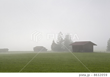 wooden huts in fog 8632059
