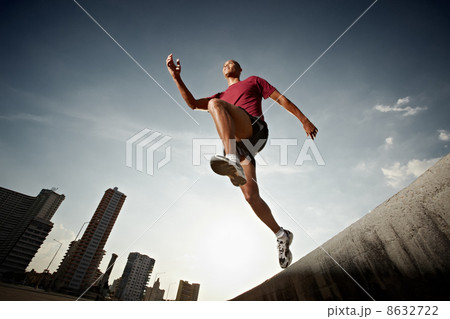 hispanic man running and jumping from a wall 8632722