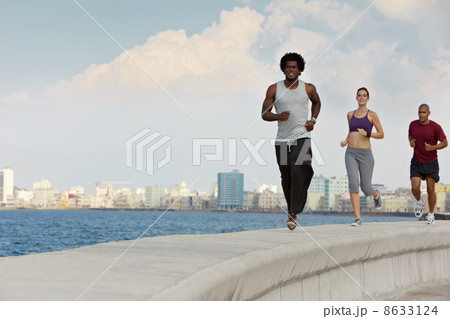 three friends doing sport activities near the sea three friends doing sport activities near the sea 8633124