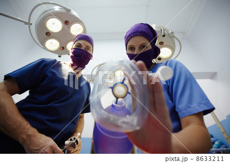 Operation room in clinic with medical staff during surgery Operation room in clinic with medical staff during surgery 8633211