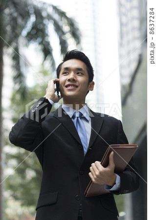 Chinese business man using a smartphone. Chinese business man using a smartphone. 8637284
