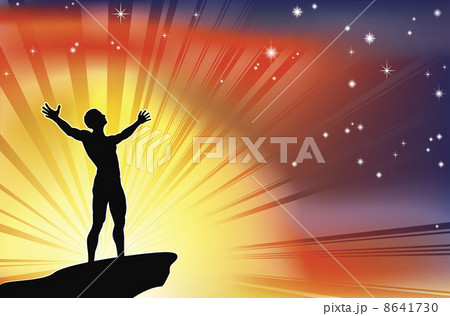 Man on cliff top with arms raised 8641730