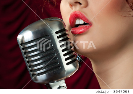 woman with red lips singing in vintage microphone 8647063