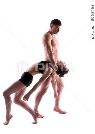 Young couple of acrobats posing in studio Young couple of acrobats posing in studio 8665468