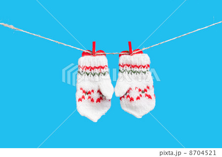 Two mittens isolated on blue background Two mittens isolated on blue background 8704521