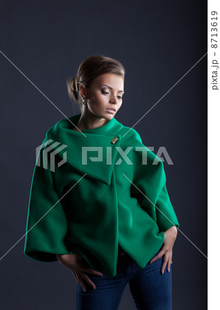 Lovely girl posing in trendy green coat, close-up 8713619