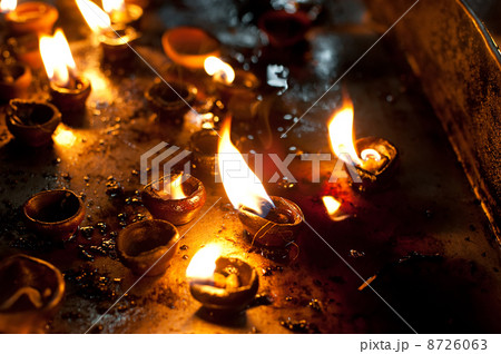 Burning oil lamps at religious temple 8726063