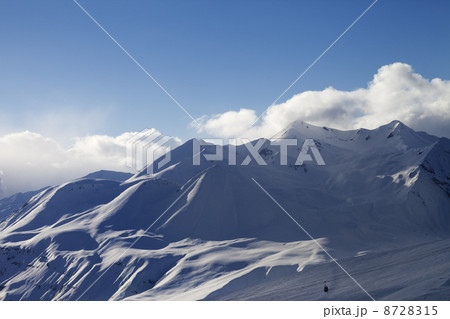 View on ski slope and sunlight mountains in evening View on ski slope and sunlight mountains in evening 8728315