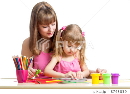 Mother and kid girl draw and cut together Mother and kid girl draw and cut together 8743059
