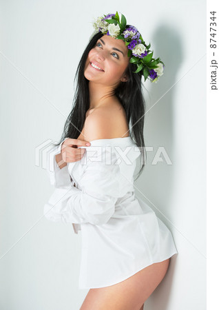 Beautiful woman wearing wreath of flowers Beautiful woman wearing wreath of flowers 8747344