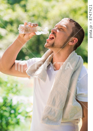 Sport fitness man. Young athletic man cooling himself Sport fitness man. Young athletic man cooling himself 8747421