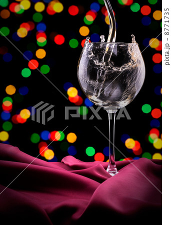 Glass of wine on red silk Glass of wine on red silk 8771735