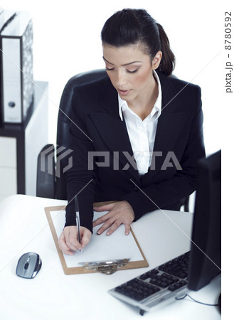 Busy business lady making her notes on the clipboard Busy business lady making her notes on the clipboard 8780592