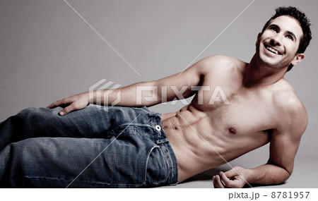Lying muscular man looking at the left corner 8781957