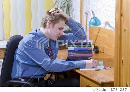 Pupil schoolboy reflected with pile of textbooks above performance of homework 8784287