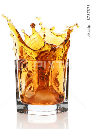 Glass with splashing whisky drink Glass with splashing whisky drink 8787378