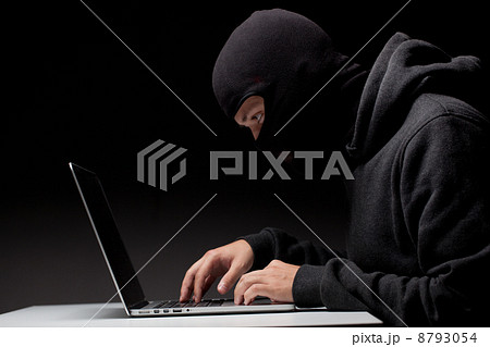Computer hacker in a balaclava Computer hacker in a balaclava 8793054