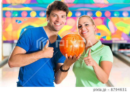 Young people playing bowling and having fun Young people playing bowling and having fun 8794631
