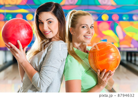 Young women playing bowling and having fun Young women playing bowling and having fun 8794632