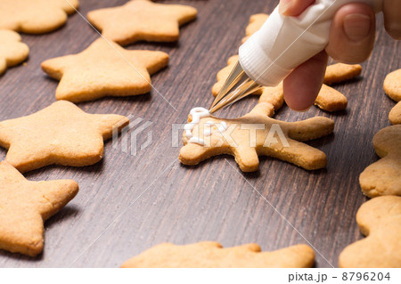 Decorating of gingerbread bears on wooden table 8796204