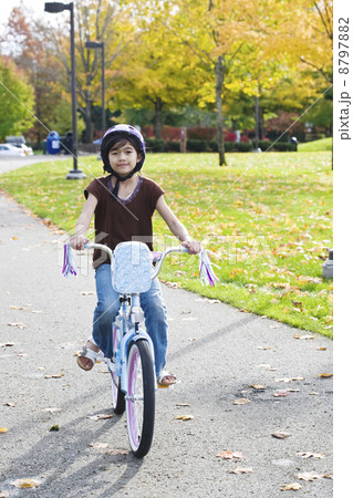 Little girl riding bike in park 8797882